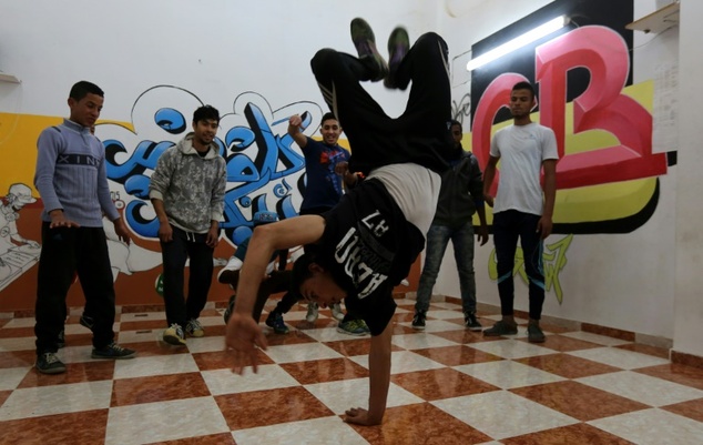 Palestinian youths practice their break dancing moves at makeshift training facilities at the Nuseirat refugee camp in the central Gaza Strip